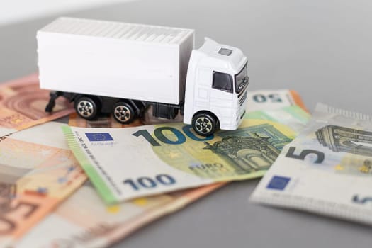 white toy truck on euro banknotes. concept for logistics, transportation and and finance. High quality photo
