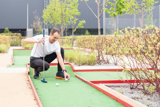 player looks at his hit on a mini golf course. High quality photo