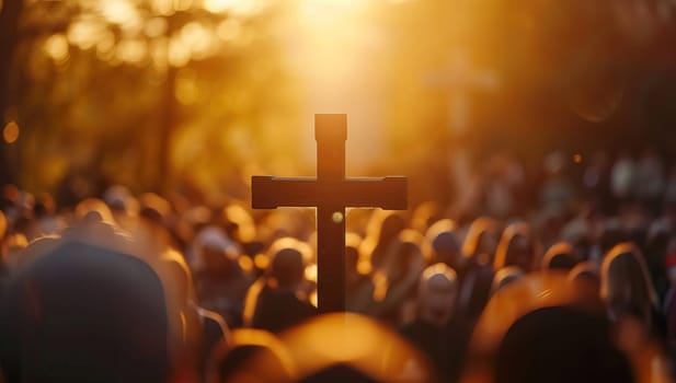 Crowd gathering around a cross in the golden hour