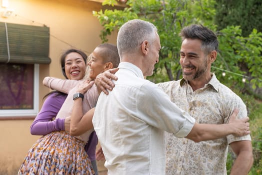 Multiethnic middle aged men and women greet each other and huddle together happily. High quality photo