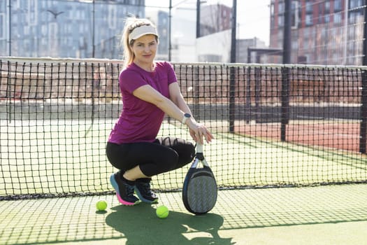 Portrait of attractive woman padel tennis player in outdoor court. High quality photo