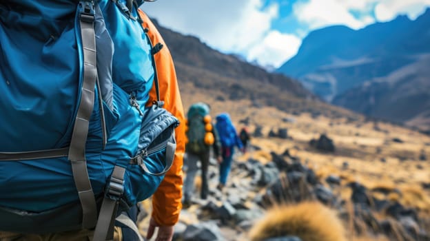 A bunch of backpackers are trekking up the majestic mountain, surrounded by the vast natural landscape, enjoying the sky, plants, and soil along the way. AIG41