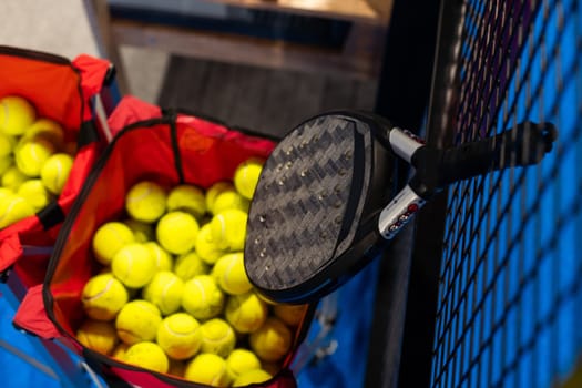 paddle tennis racket and balls on court, night image. High quality photo