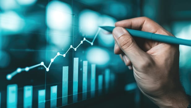 Hand analyzing financial data on digital screen