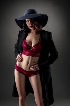 Stylishly dressed woman showing her erotic underwear
