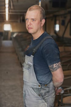 Ringkobing, Denmark, April 28, 2024: Worker at a modern pig farm.