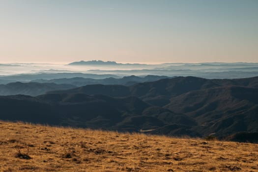 The tranquil beauty of a mountain range is painted with the soft hues of early morning.