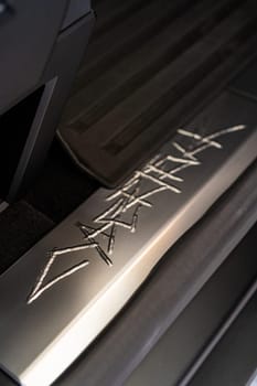 Denver, Colorado, USA-May 5, 2024-This image showcases the distinctive metal engraving of the Cybertruck logo on the interior of a Tesla Cybertruck, highlighting the vehicle unique branding elements and detailed craftsmanship.