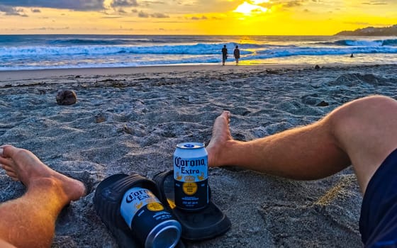 Modelo beer can on the beach at sunset in Zicatela Puerto Escondido Oaxaca Mexico.