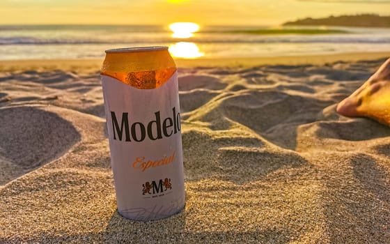 Modelo beer can on the beach at sunset in Zicatela Puerto Escondido Oaxaca Mexico.