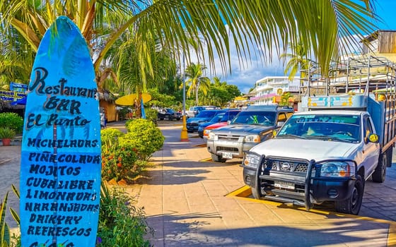 Advertising sign on surfboard surf board in Zicatela Puerto Escondido Oaxaca Mexico.