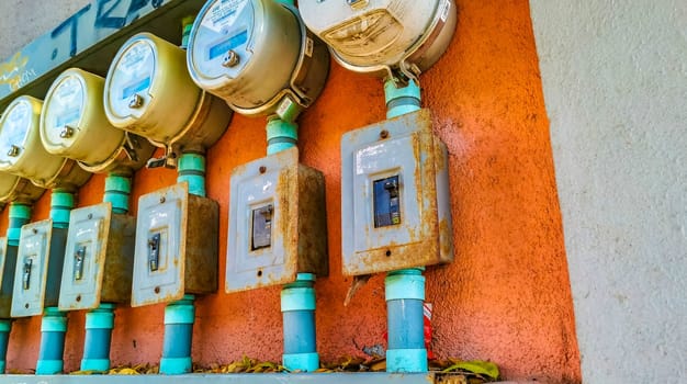 Old broken electricity meters on the wall in Zicatela Puerto Escondido Oaxaca Mexico.