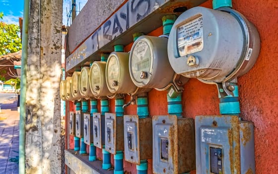 Old broken electricity meters on the wall in Zicatela Puerto Escondido Oaxaca Mexico.