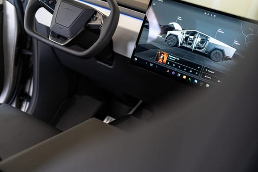 Denver, Colorado, USA-May 5, 2024-The interior of a Tesla Cybertruck showcasing its advanced touchscreen display, which is centrally located between the driver and passenger seats. This image highlights the modern design and technological features of the electric vehicle.