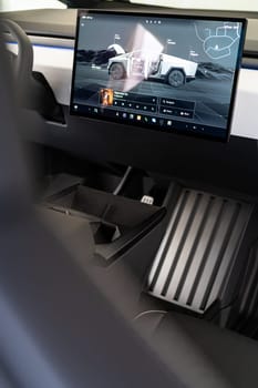 Denver, Colorado, USA-May 5, 2024-The interior of a Tesla Cybertruck showcasing its advanced touchscreen display, which is centrally located between the driver and passenger seats. This image highlights the modern design and technological features of the electric vehicle.