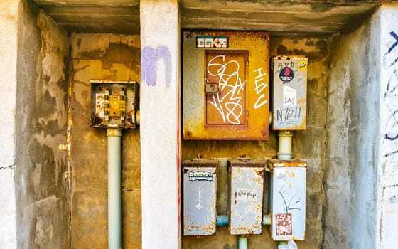 Old broken electricity meters on the wall in Zicatela Puerto Escondido Oaxaca Mexico.