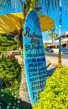 Advertising sign on surfboard surf board in Zicatela Puerto Escondido Oaxaca Mexico.