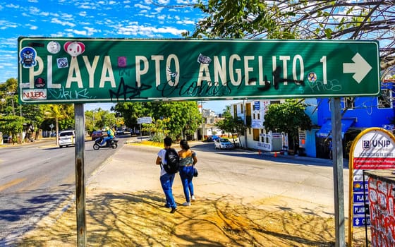 Green Playa Puerto Angelito Beach road street signs and name for orientation of streets and roads in Zicatela Puerto Escondido Oaxaca Mexico.