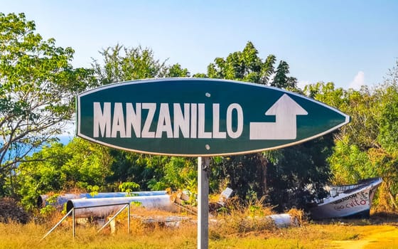 Advertising direction sign on surfboard surf board to Playa Manzanillo in Zicatela Puerto Escondido Oaxaca Mexico.