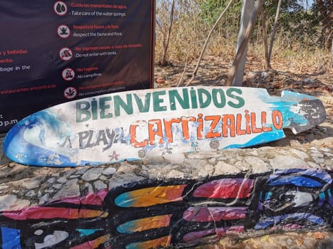 Advertising sign on surfboard surf board Beach Playa Carrizalillo in Zicatela Puerto Escondido Oaxaca Mexico.