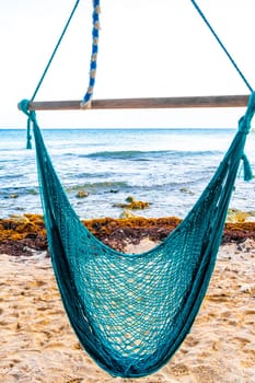 Hammock on a tropical paradisiacal beach in the Caribbean in Playa del Carmen Quintana Roo Mexico.