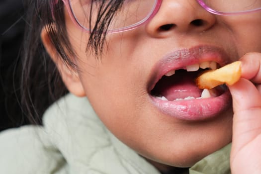 child eating french fries close up ,