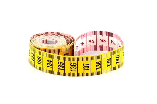 Spirals of yellow tape measure create a visual impression of motion, isolated white background