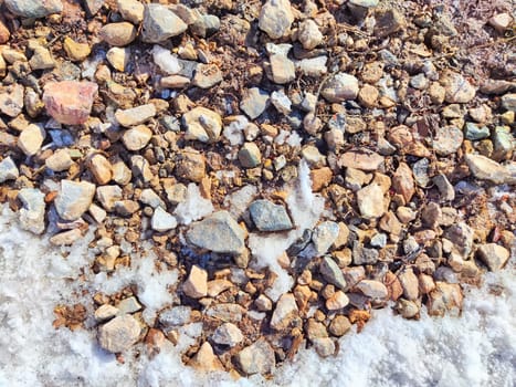 Small pebbles in the snow as background and texture. Heart-Shaped Rock Arrangement on Wall. Background, texture, pattern, frame, copy space