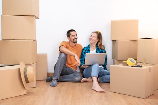 Attractive young couple with moving boxes becoming independent and opening a new home household move. High quality photo
