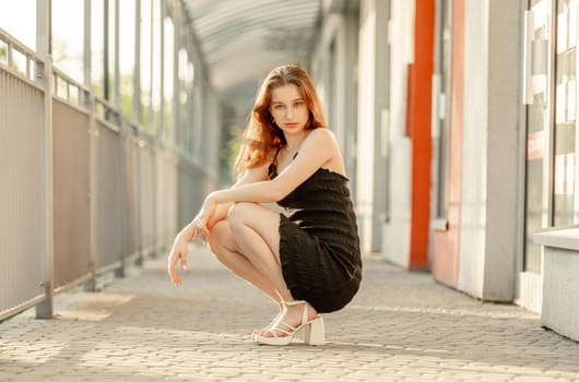 Young Girl Poses In Fashion Style On The Street In A Dress
