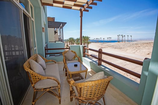 Terrace furniture of a luxury apartment in tropical resort with furniture and sea view from balcony