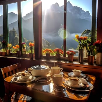 A table displays elegantly arranged dishes against a backdrop of majestic mountain ranges visible through the window, creating a stunning dining experience.