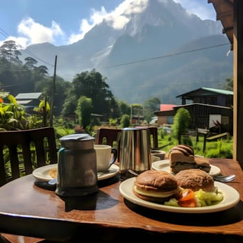 A table displays elegantly arranged dishes against a backdrop of majestic mountain ranges visible through the window, creating a stunning dining experience.