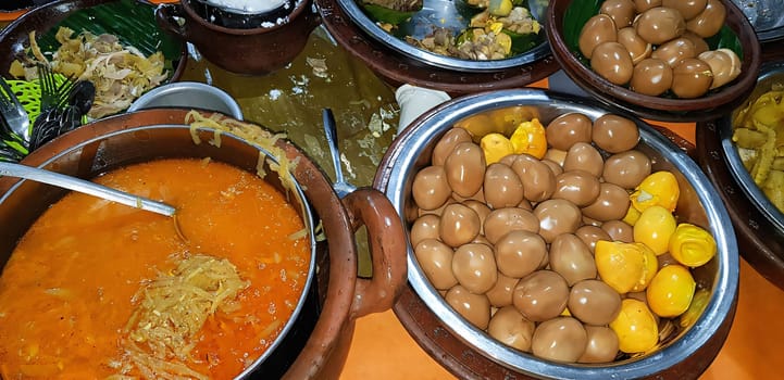 dishes served in Indonesian food Liwet Rice. A Traditional javanese Rice Served with Chicken, Tofu, Tempeh, vegetable, Chili, egg in street food