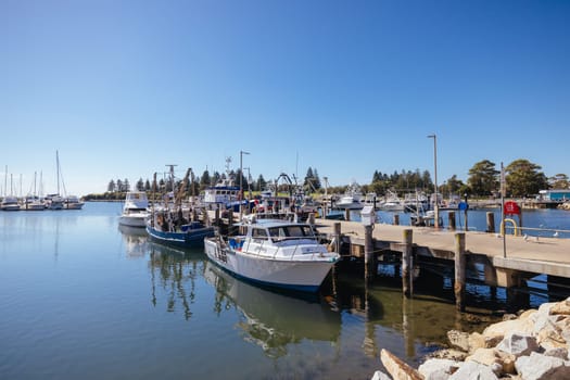 BERMAGUI, AUSTRALIA - April 3 2024: Bermagui Wharf and Marina on the Bermagui River in Bega Shire, New South Wales, Australia