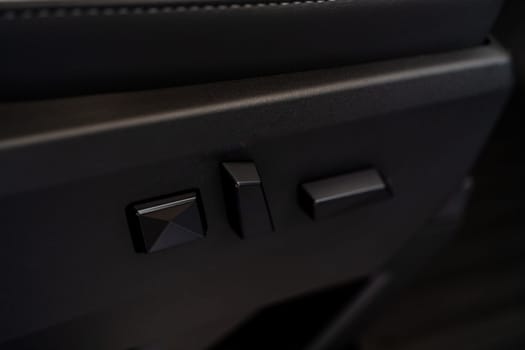 Denver, Colorado, USA-May 5, 2024-This image captures a close-up view of the seat adjustment buttons located in the Tesla Cybertruck, emphasizing the minimalist and sleek design of the vehicle interior controls.