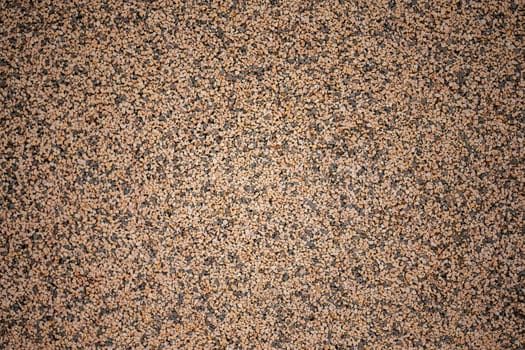Detailed close up of a surface with brown and black speckles.