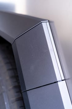 Denver, Colorado, USA-May 5, 2024-This image captures a close-up view of the Tesla Cybertruck, highlighting the intricate design and angular lines of its exterior. The focus on the edge of the panel and the textured surface showcases the unique aesthetic of Tesla innovative electric truck.