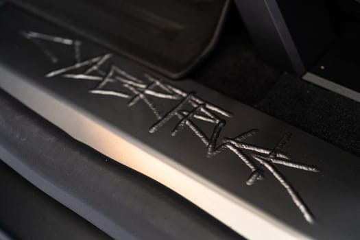 Denver, Colorado, USA-May 5, 2024-This image showcases the distinctive metal engraving of the Cybertruck logo on the interior of a Tesla Cybertruck, highlighting the vehicle unique branding elements and detailed craftsmanship.