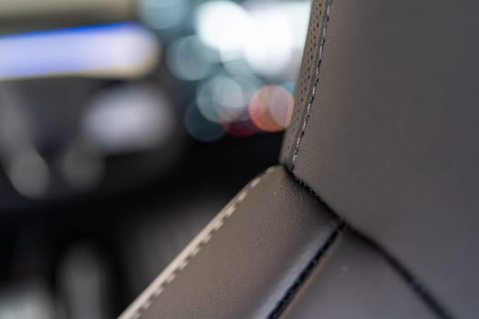 Denver, Colorado, USA-May 5, 2024-This image captures a detailed close-up view of the intricate stitching on a leather seat inside a Tesla Cybertruck, showcasing the high-quality materials and craftsmanship.