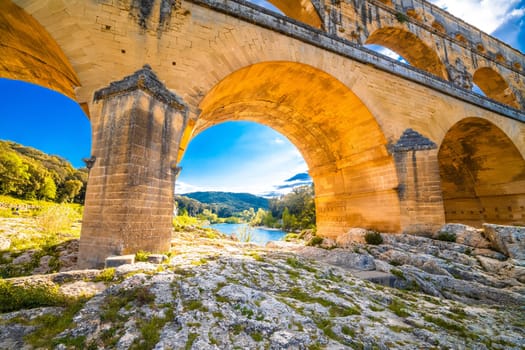 The Pont du Gard ancient Roman aqueduct bridge arches view. It crosses the river Gardon near the town of Vers-Pont-du-Gard in southern France.