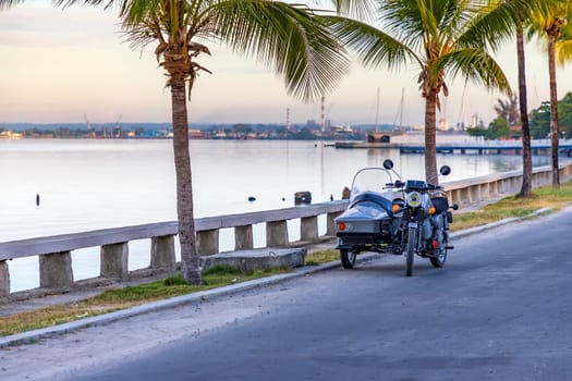 Recovered motorcycle with Sidecar parked near the sea.