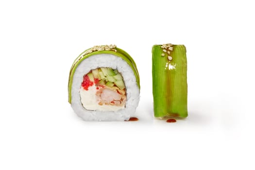 Closeup of appetizing sushi roll filled with tempura shrimp, cream cheese, cucumber and tobiko roe wrapped in thin avocado slices, isolated on white background