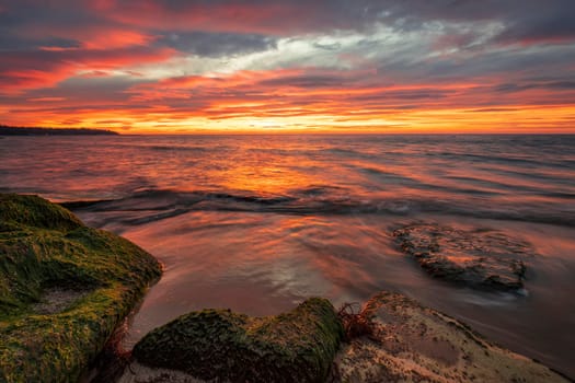 Amazing red sunrise over the sea.	