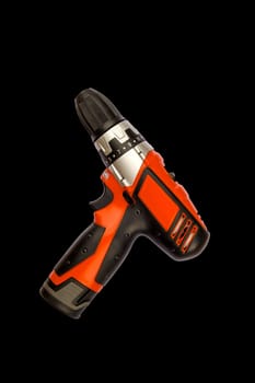 Cordless drill screwdriver isolated on black background. Professional tool