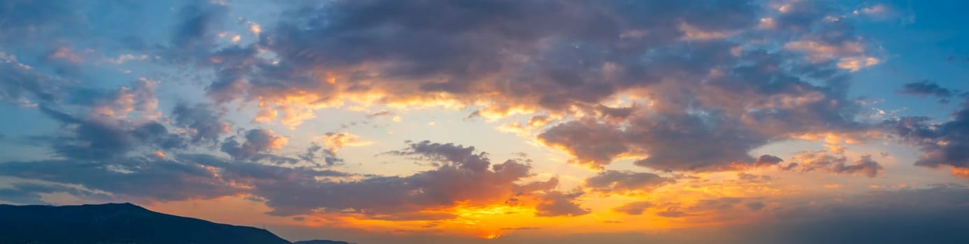 Stunning colorful clouds in the sunset sky. Panoramic view. Natural background.