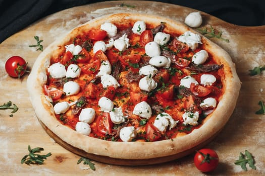 A Margherita pizza topped with cherry tomatoes, mozzarella dollops, and basil rests on a wooden peel.