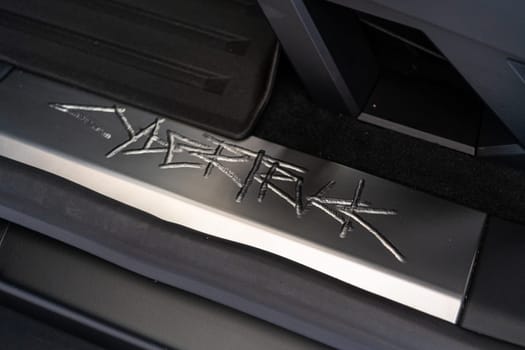 Denver, Colorado, USA-May 5, 2024-This image showcases the distinctive metal engraving of the Cybertruck logo on the interior of a Tesla Cybertruck, highlighting the vehicle unique branding elements and detailed craftsmanship.