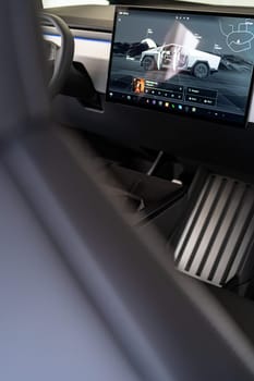 Denver, Colorado, USA-May 5, 2024-The interior of a Tesla Cybertruck showcasing its advanced touchscreen display, which is centrally located between the driver and passenger seats. This image highlights the modern design and technological features of the electric vehicle.
