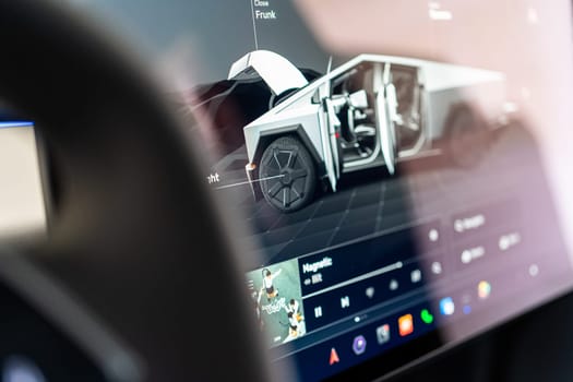 Denver, Colorado, USA-May 5, 2024-The interior of a Tesla Cybertruck showcasing its advanced touchscreen display, which is centrally located between the driver and passenger seats. This image highlights the modern design and technological features of the electric vehicle.